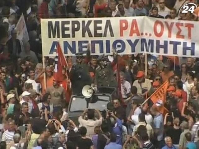 В Афинах тысячи людей протестовали против визита Меркель В Афинах тысячи людей протестовали против визита Меркель