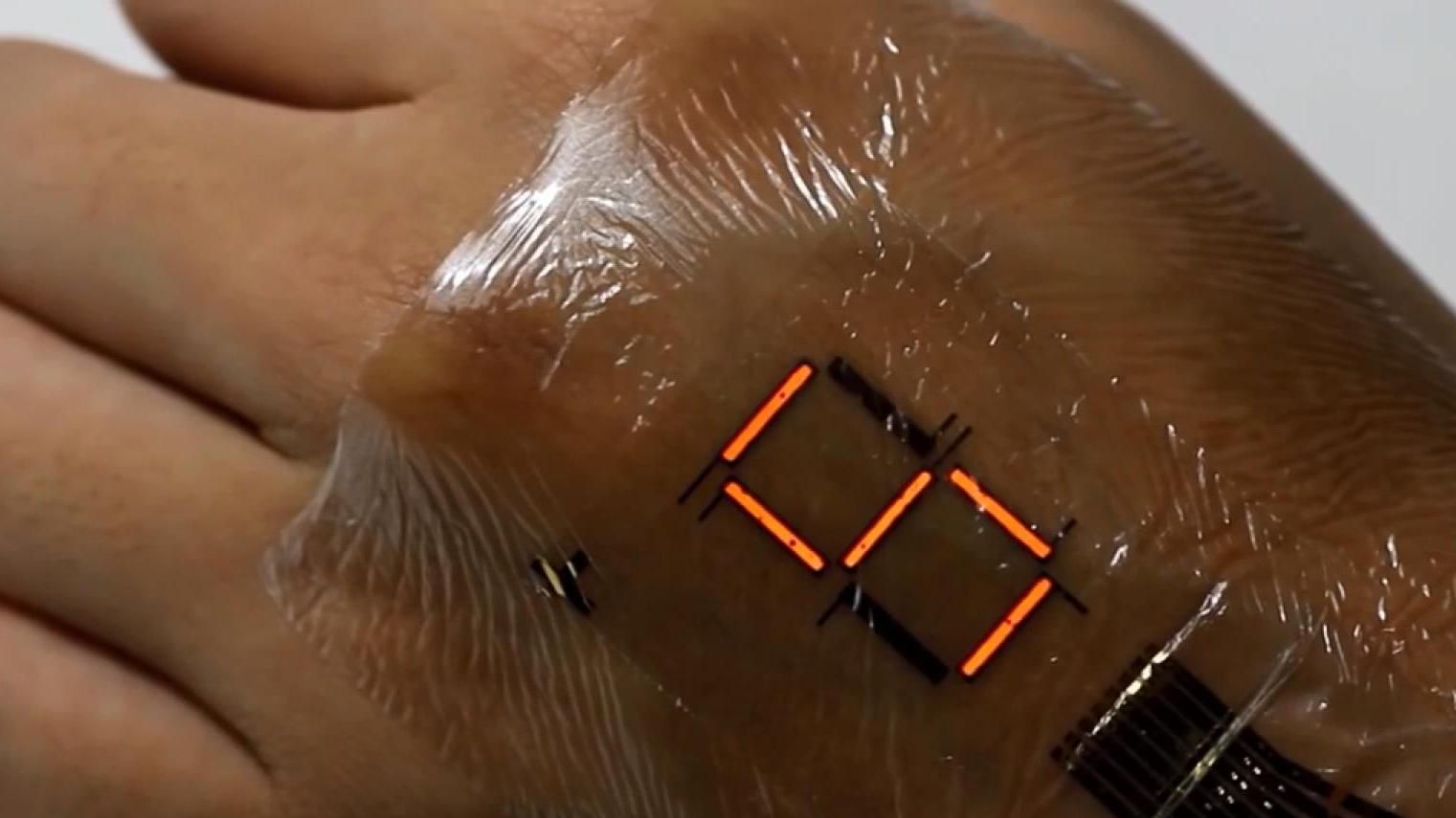 Ученые создали сверхтонкий дисплей, который крепится к телу человека Ученые создали сверхтонкий дисплей, который крепится к телу человека