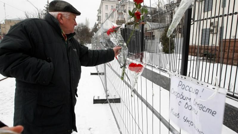 Падение российского самолета: к посольству в Киеве тоже сносят цветы и лампадки