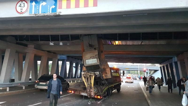 Курйозна аварія у Києві: евакуатор застряг під мостом і спричинив довжелезний затор 