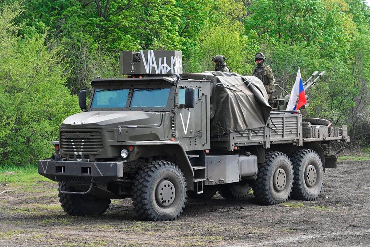 Російські окупанти у вантажівці з прапорами Росії Російські окупанти у вантажівці з прапорами Росії